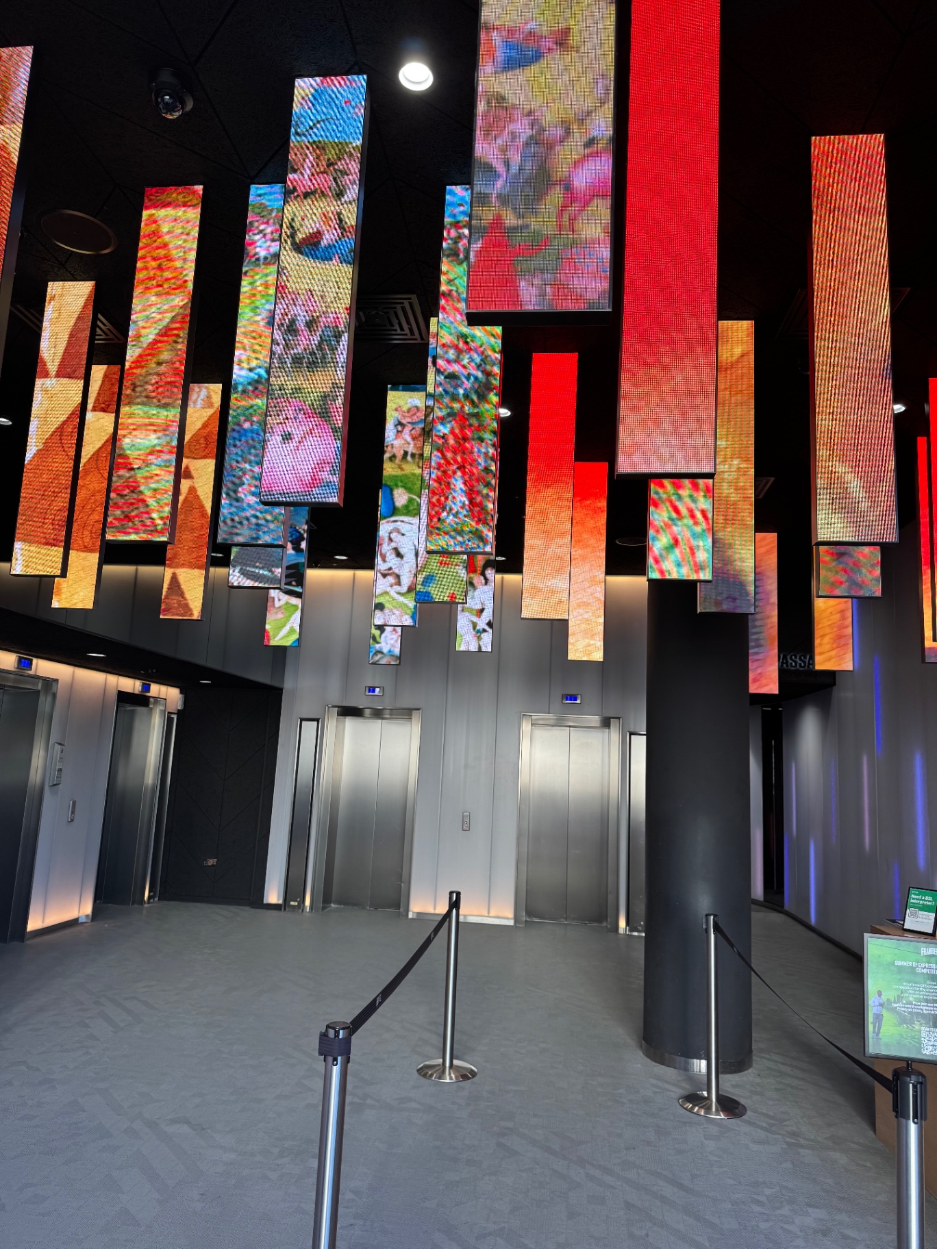 Immersive digital art installation with vibrant colour panels suspended from the ceiling